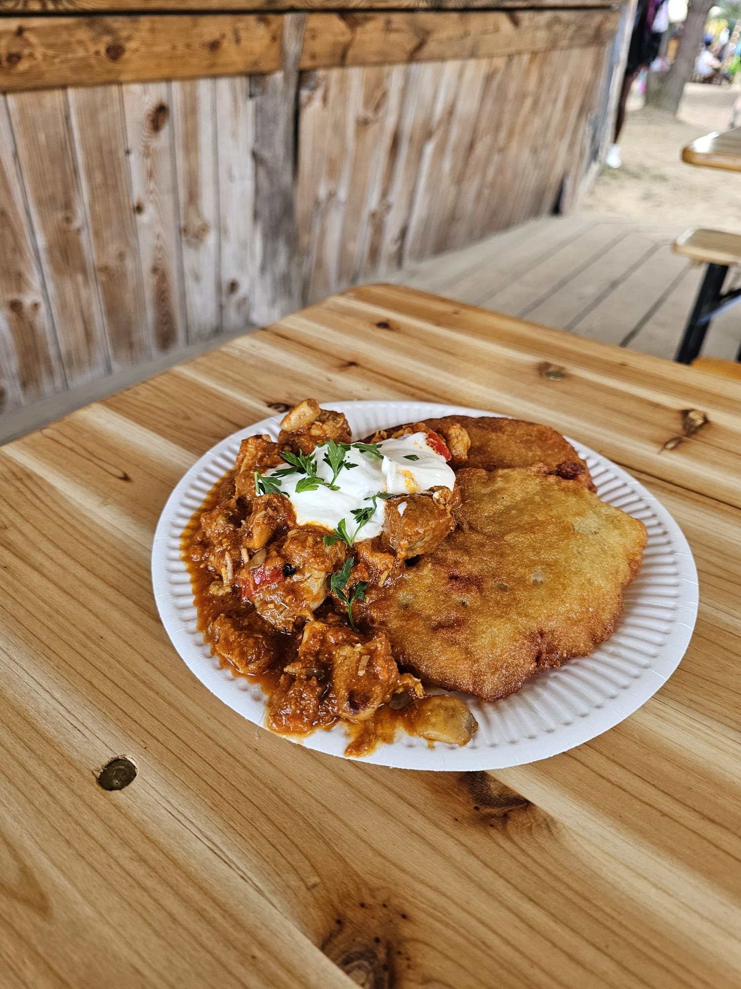 Potato pancakes with goulash and sour cream served at Kuchnia Polska