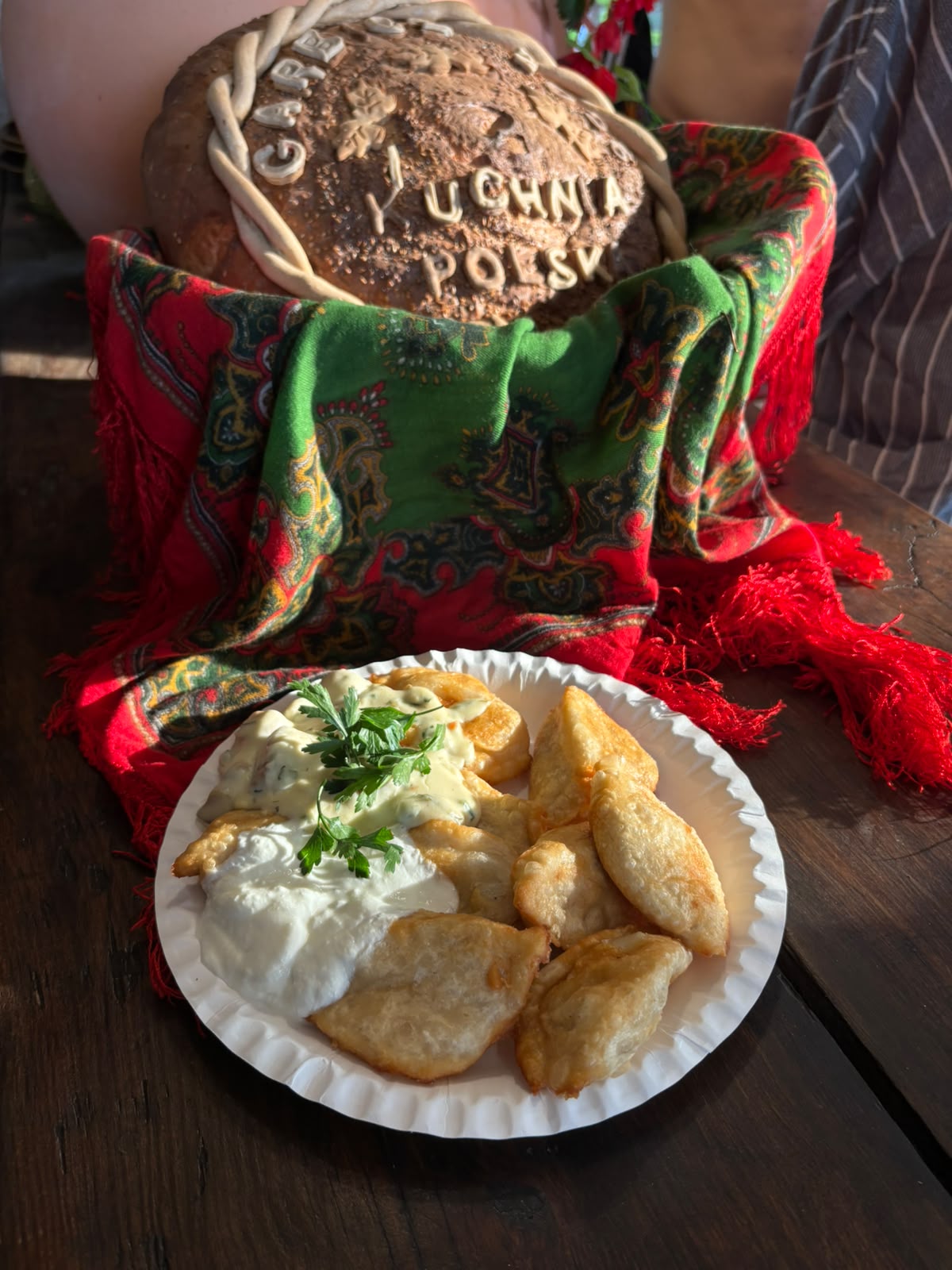 Golden pierogi served with sauces and parsley at Kuchnia Polska